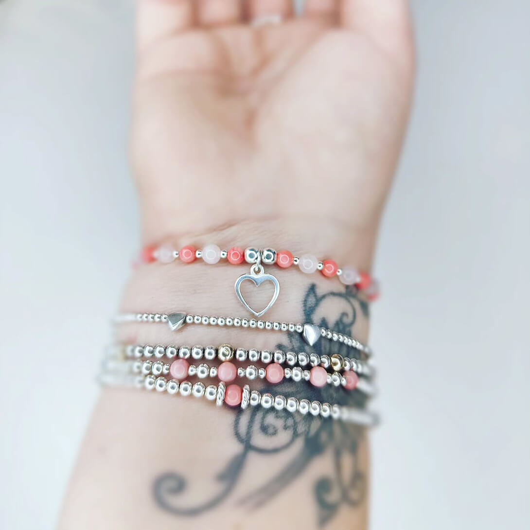 Bracelets on an arm made up of colourful gemstones