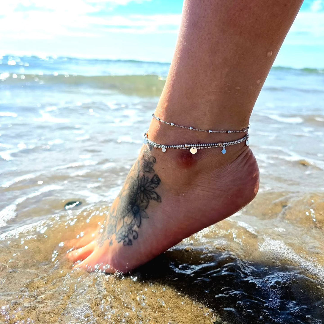 Leg in the sea wearing Sterling Silver bracelets