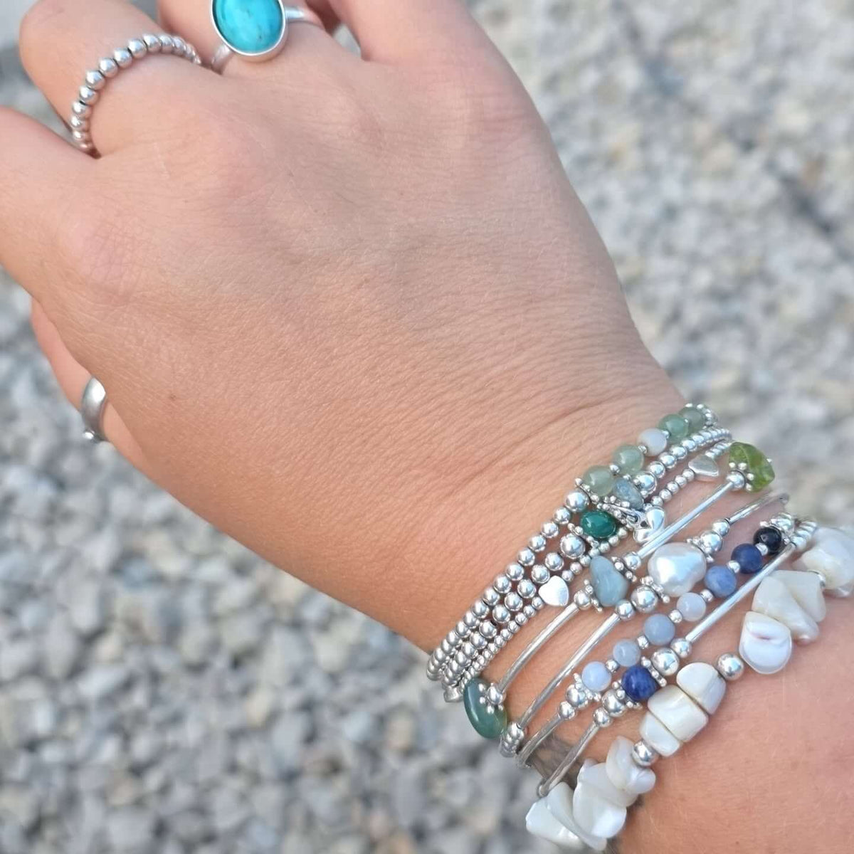 Create Your Own bracelets stacked on a wrist